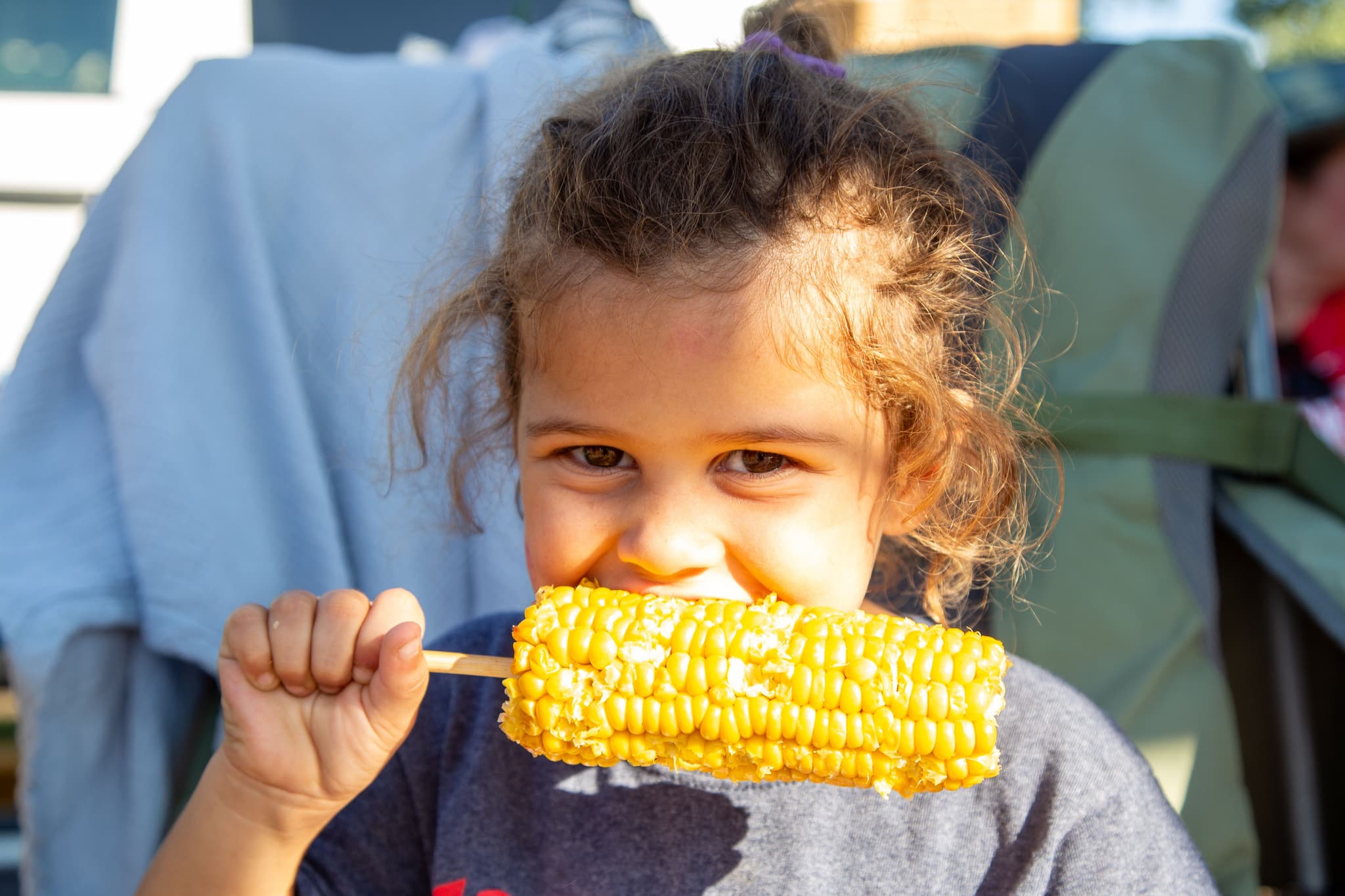 A child enjoys delicious grilled corn on the cob from the many food vendors at GorettiFest
