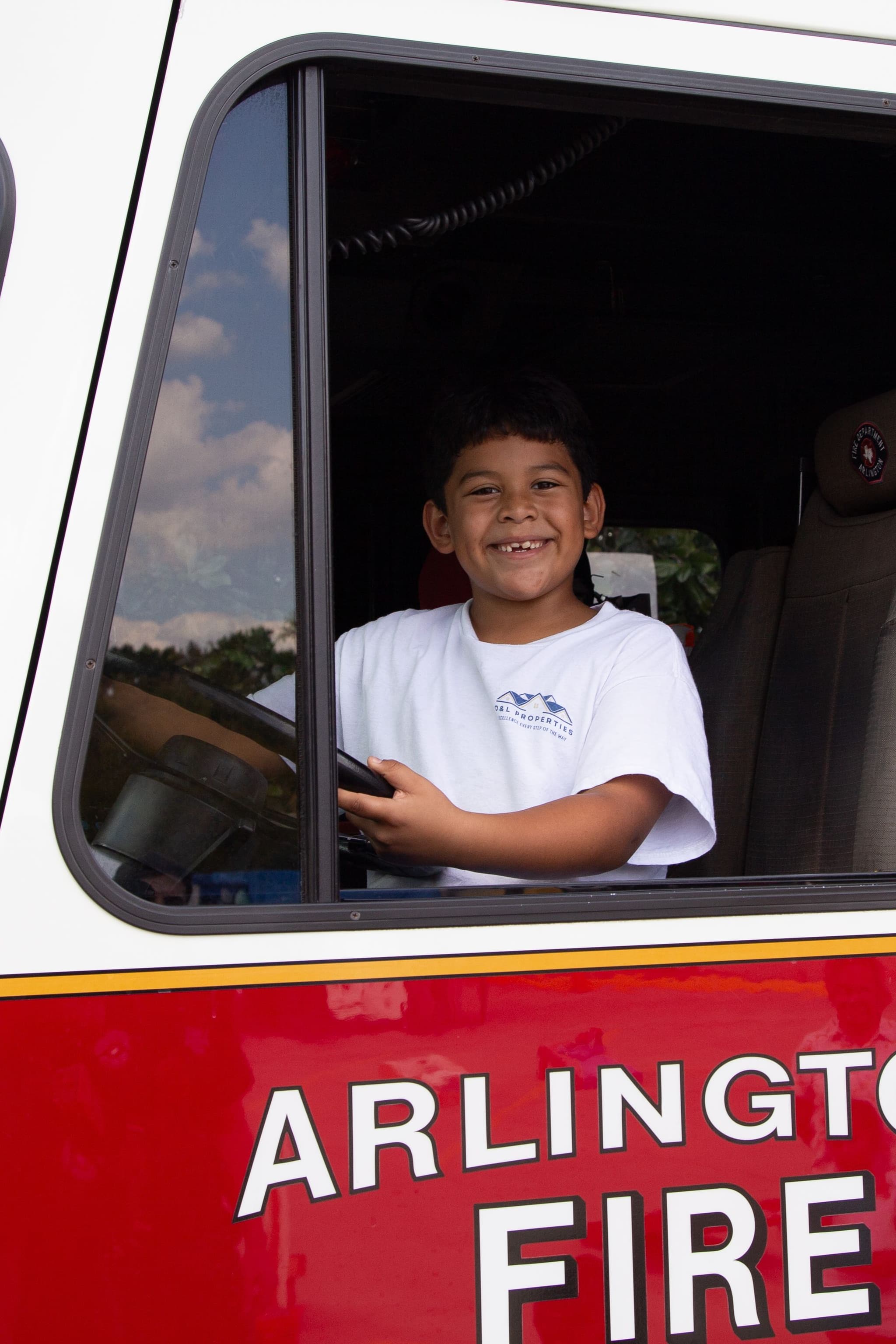 A young boy at GorettiFest gets to experience being at the wheel of an Arlington Fire Department truck
